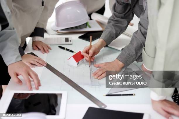 close up of architects reviewing blueprints in office - 2018 blueprint stock pictures, royalty-free photos & images