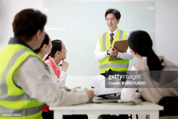 businessman leading presentation in meeting room - japan training session stock pictures, royalty-free photos & images