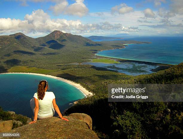 woman enjoying the view of wine glass bay - wineglass bay stock pictures, royalty-free photos & images