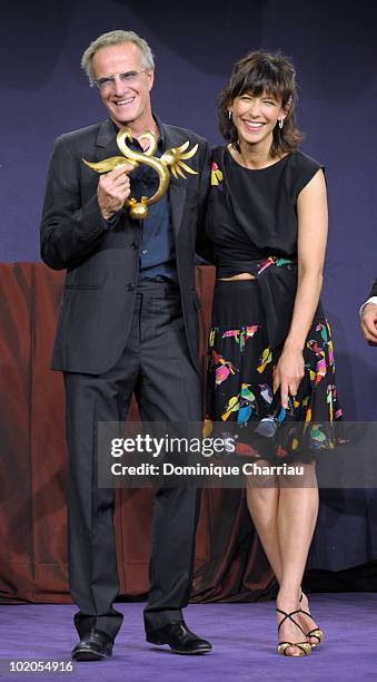 Actress Sophie Marceau presents the Award "Coup de Coeur" to Actor Christopher Lambert on June 12, 2010 in Cabourg, France.