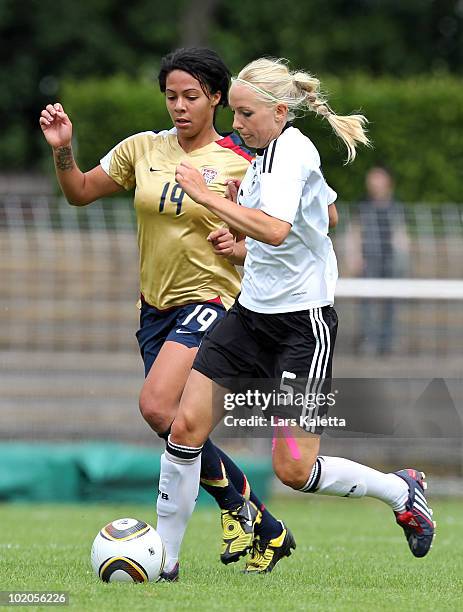 Kristina Gessat of Germany challenges Sydney Leroux of USA during the DFB women's U20 match between Germany and USA at the Ludwig-Jahn-Stadion on...