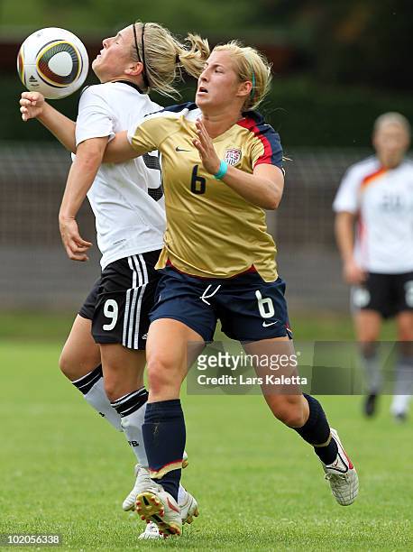 Svenja Huth of Germany challenges Kendall Johnson of USA during the DFB women's U20 match between Germany and USA at the Ludwig-Jahn-Stadion on June...