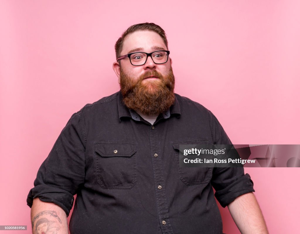 Bearded man on pink background.