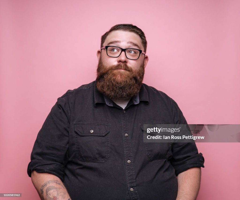 Bearded man on pink background.