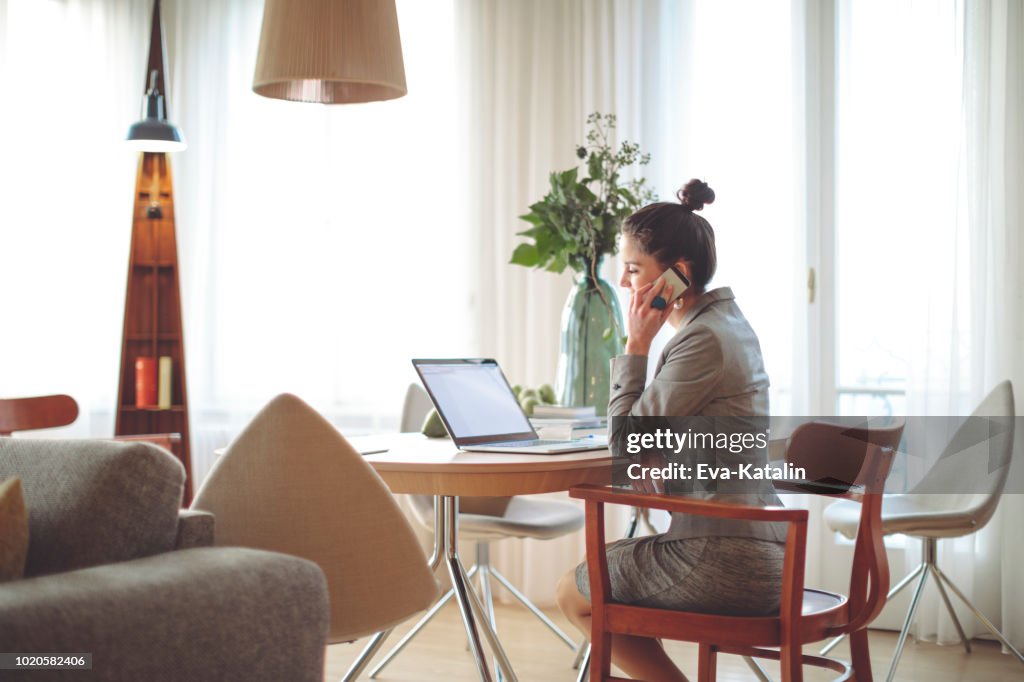 Young Woman Is Working From Home Using Mobile Devices High-Res Stock ...