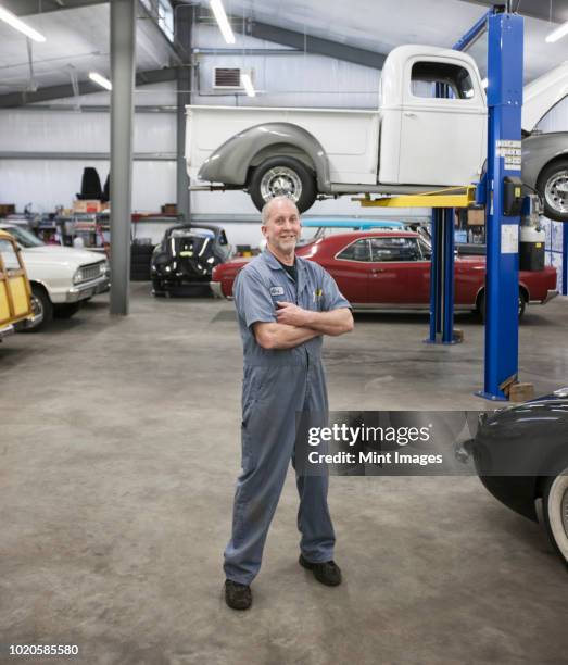 portrait of a senior caucasian male owner of an antique car repair shop - antique car bildbanksfoton och bilder