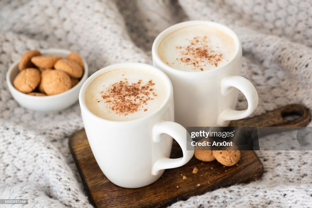 Cappucino or latte with cinnamon and cookies