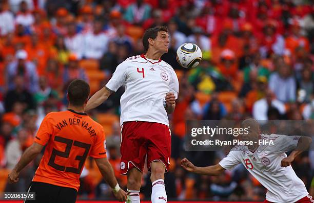 Simon Poulsen of Denmark heads the ball and hitting the back of his team mate Daniel Agger and scores an own goal during the 2010 FIFA World Cup...