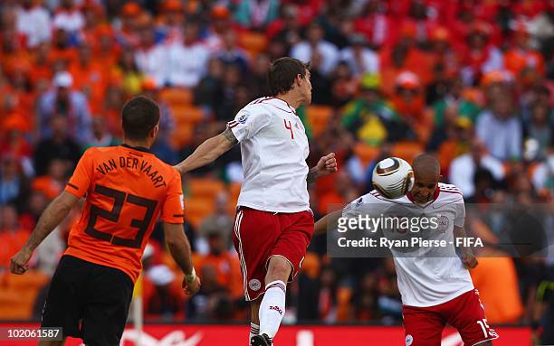 Simon Poulsen of Denmark heads the ball and hits the back of his team mate Daniel Agger scoring an own goal during the 2010 FIFA World Cup Group E...