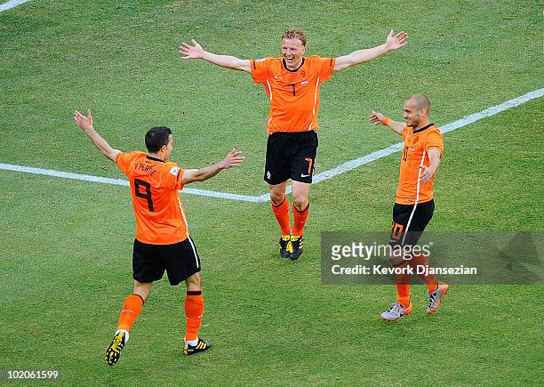 Robin Van Persie, Dirk Kuyt and Wesley Sneijder of the Netherlands celebrate the own goal by Simon Poulsen during the 2010 FIFA World Cup Group E...