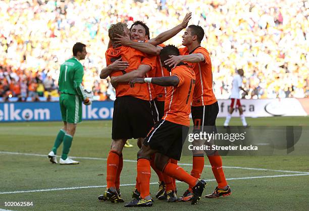 Dirk Kuyt of the Netherlands celebrates with team mates after scoring the second goal during the 2010 FIFA World Cup Group E match between...