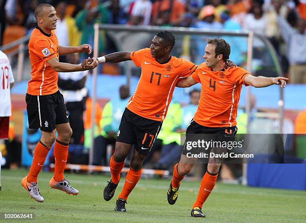 Eljero Elia of the Netherlands celebrates with team mates John Heitinga and Joris Mathijsen after his shot hit the post and Dirk Kuyt scores from the...