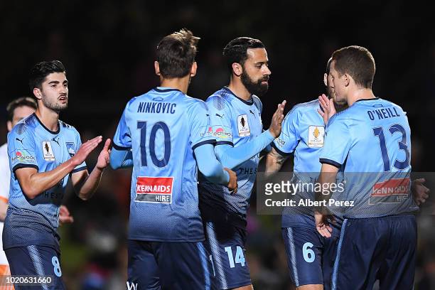 Alex Brosque of Sydney FC celebrates with team mates after scoring a goal during the FFA Cup round of 16 match between Cairns FC and Sydney FC at...