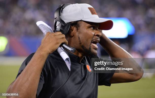 Assistant coach Joshua Cribbs yells instructions from the sideline in the fourth quarter of a preseason game against the New York Giants at MetLife...