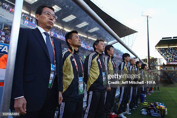 Takeshi Okada head coach of Japan and his team stand during their National Anthm prior to the 2010 FIFA World Cup South Africa Group E match between...
