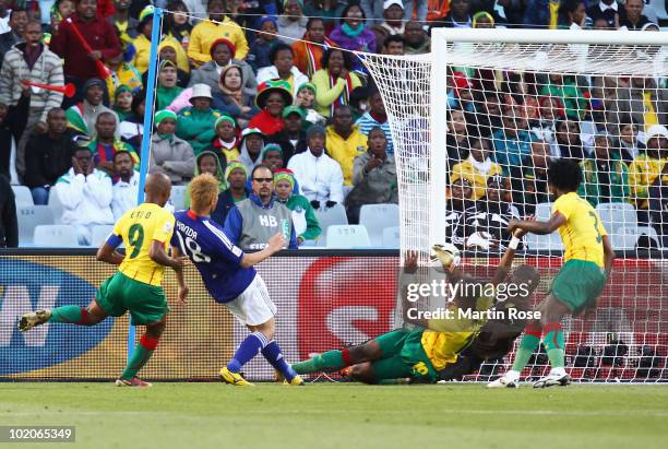 Keisuke Honda of Japan scores the first goal past Hamidou Souleymanou of Cameroon during the 2010 FIFA World Cup South Africa Group E match between...