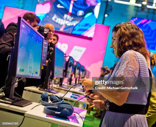 German State Minister for Digitization Dorothee Baer tries out Fifa 19 video game at 2018 Gamescom video games trade fair press day on August 21,...