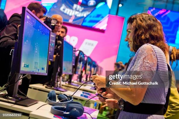 German State Minister for Digitization Dorothee Baer tries out Fifa 19 video game at 2018 Gamescom video games trade fair press day on August 21,...