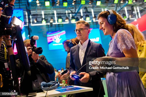 German State Minister for Digitization Dorothee Baer tries out Fifa 19 video game at 2018 Gamescom video games trade fair press day on August 21,...