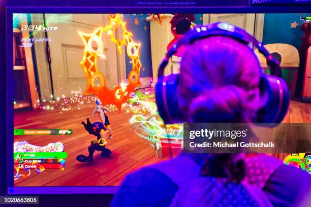 Visitors try video games at 2018 gamescom fair press day on August 21, 2018 in Cologne, Germany. Gamescom is Europe's biggest trade fair for the...