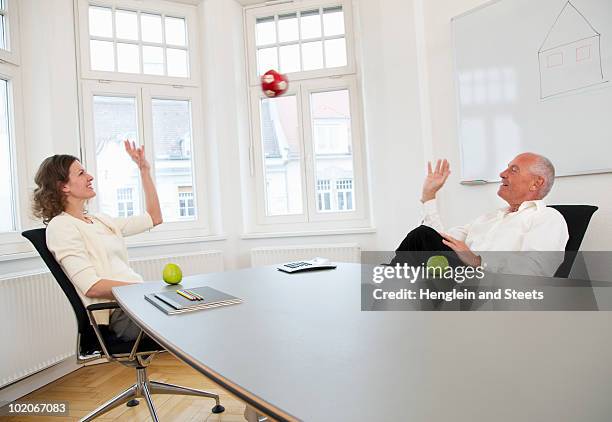 businesspeople relaxing on a break - ball chair foto e immagini stock