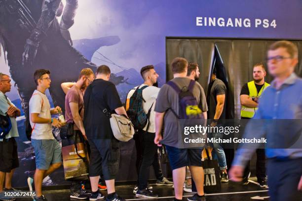 Visitors wait in a row to try video games at 2018 gamescom fair press day on August 21, 2018 in Cologne, Germany. Gamescom is Europe's biggest trade...