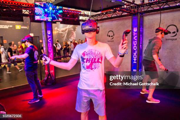 Visitors try virtual reality video games at 2018 gamescom fair press day on August 21, 2018 in Cologne, Germany. Gamescom is Europe's biggest trade...