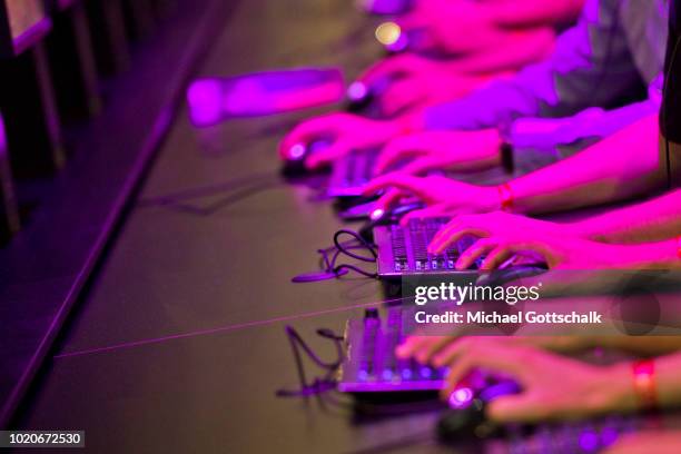 Visitors sit in a row and try video games at 2018 gamescom fair press day on August 21, 2018 in Cologne, Germany. Gamescom is Europe's biggest trade...