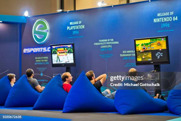 Visitors try video games at esports booth at 2018 gamescom fair press day on August 21, 2018 in Cologne, Germany. Gamescom is Europe's biggest trade...