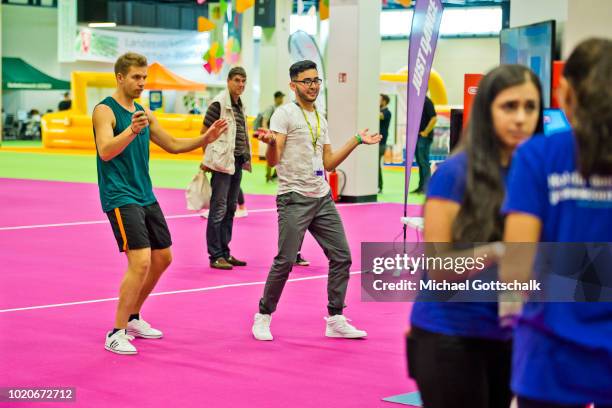 Visitors try an interactive sports video games at 2018 gamescom fair press day on August 21, 2018 in Cologne, Germany. Gamescom is Europe's biggest...