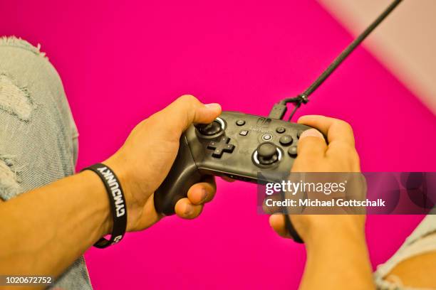 Visitors tries a video game at Nintendo booth at 2018 gamescom fair press day on August 21, 2018 in Cologne, Germany. Gamescom is Europe's biggest...