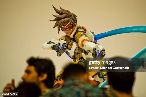 Visitors wait in a row in front of video game characters at 2018 gamescom fair press day on August 21, 2018 in Cologne, Germany. Gamescom is Europe's...