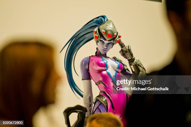 Visitors wait in a row in front of video game characters at 2018 gamescom fair press day on August 21, 2018 in Cologne, Germany. Gamescom is Europe's...