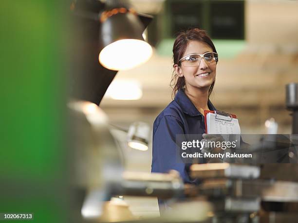 female apprentice with clipboard - monty rakusen portrait stock pictures, royalty-free photos & images