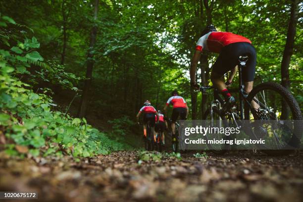 group of men mountain biking in nature - cycling team stock pictures, royalty-free photos & images