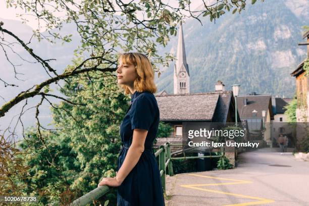 young woman walking in hallstatt - village stock-fotos und bilder