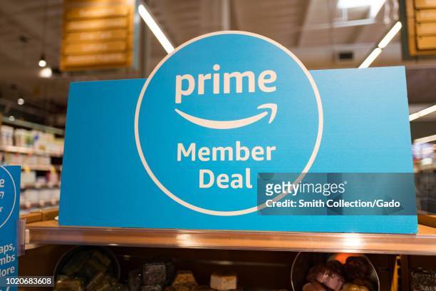Sign on grocery endcap reading Prime Member Deal, advertising discounts for Amazon Prime members at a Whole Foods Market grocery store in San Ramon,...
