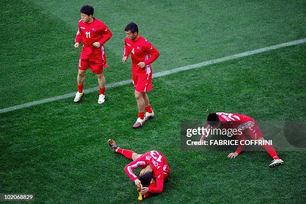 North Korea's midfielder Mun In-Guk, midfielder Pak Nam-Chol, North Korea's defender Pak Chol-Jin and goalkeeper Kim Myon-Won warm up during a...