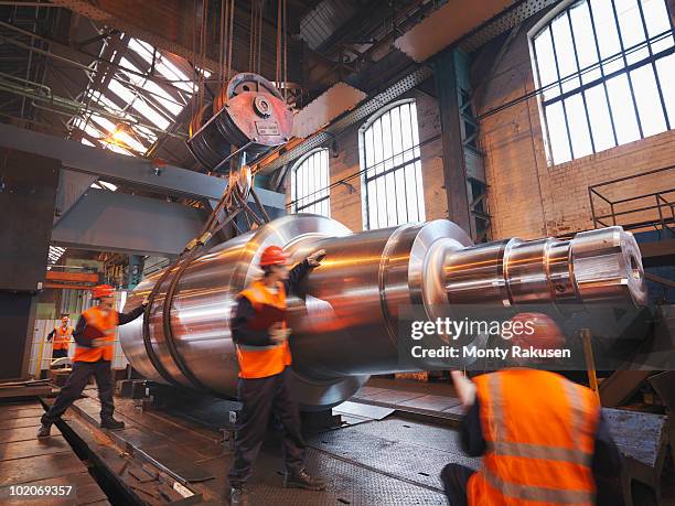 engineers with finished steel product - maquinaria de fábrica fotografías e imágenes de stock