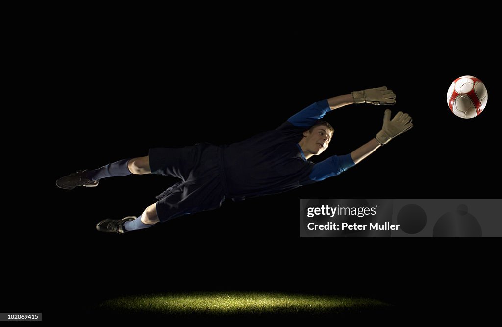 Goalkeeper diving for ball