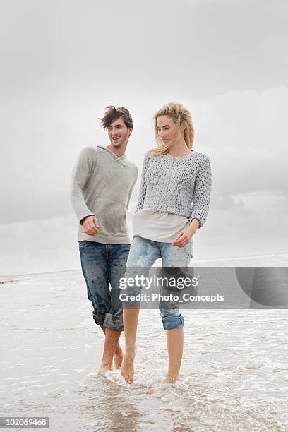 couple on beach in autumn - rolled up pants stock pictures, royalty-free photos & images