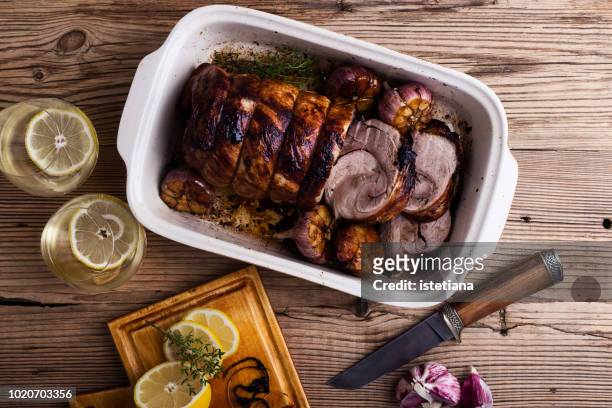 roast herb rolled pork meat with garlic - roast pig stock pictures, royalty-free photos & images