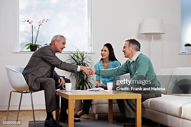 couple with financial adviser - sold palabra en inglés fotografías e imágenes de stock