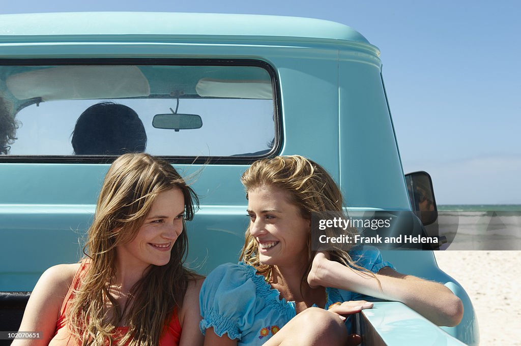 Teenage girls on back of pickup truck