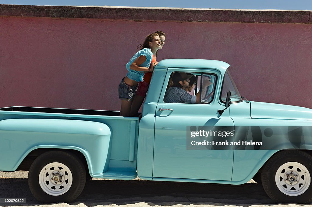 5 young people traveling in pickup truck