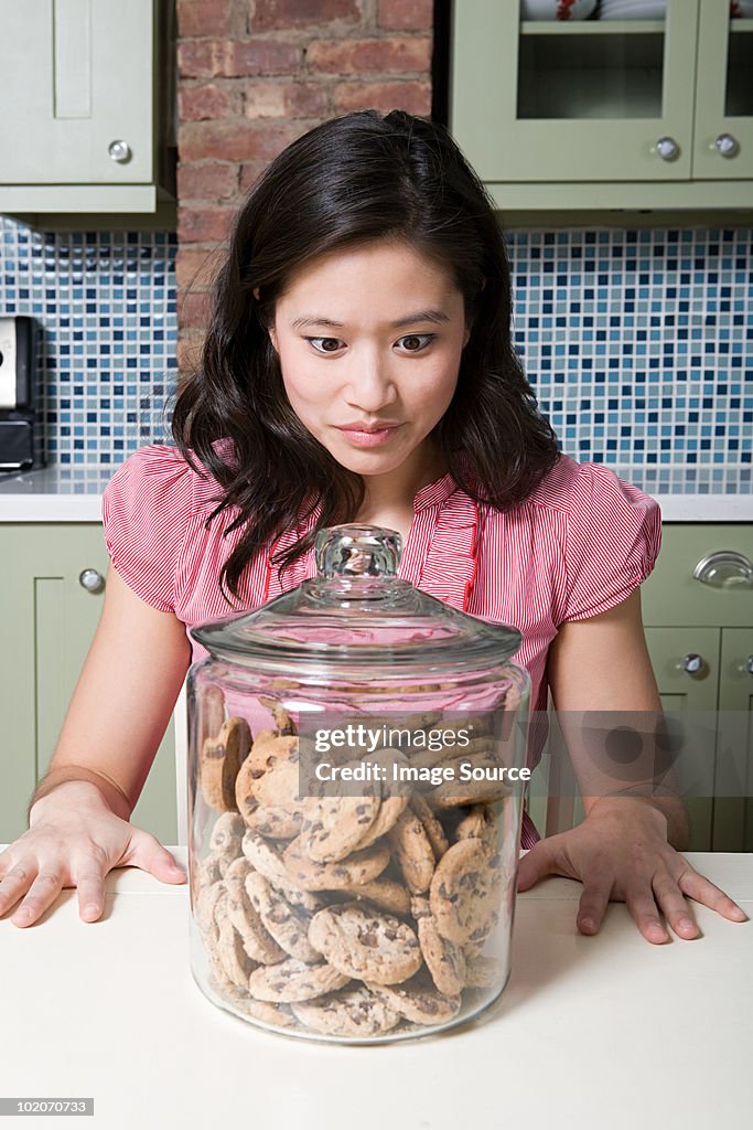 Young woman with cookie jar