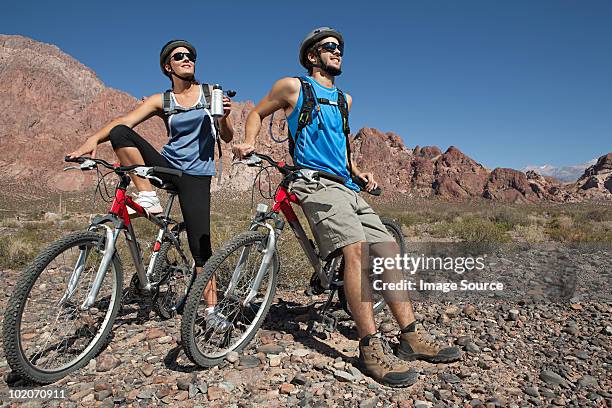 mountain biker couple taking a break - mendoza stock pictures, royalty-free photos & images