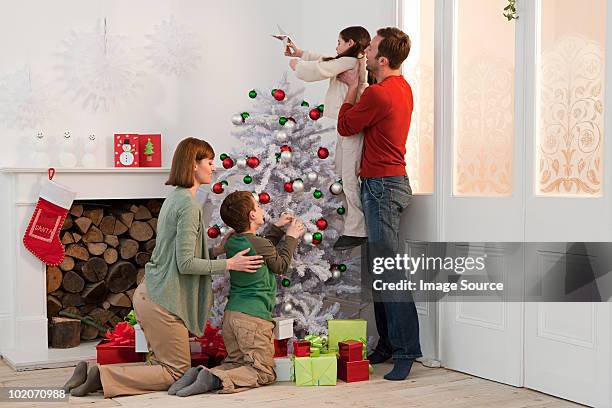 family enjoying christmas together - positioned stock pictures, royalty-free photos & images