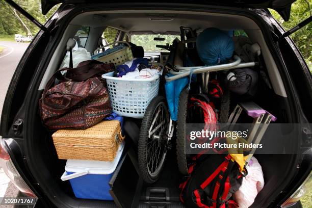 rear of suv vehicle packed with camping gear  - car full stock-fotos und bilder