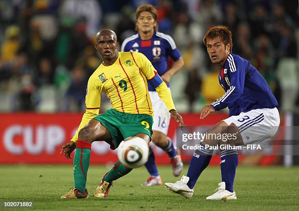 Samuel Eto'o of Cameroon and Yuichi Komano of Japan battle for the ball during the 2010 FIFA World Cup South Africa Group E match between Japan and...
